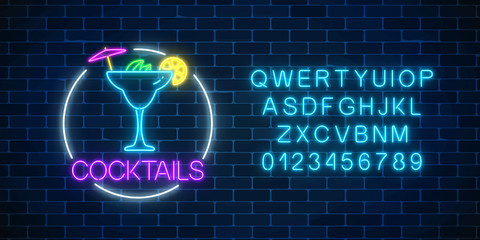 Neon sambuca cocktail sign in circle frame with alphabet. Glowing gas advertising with glass of alcohol shake.