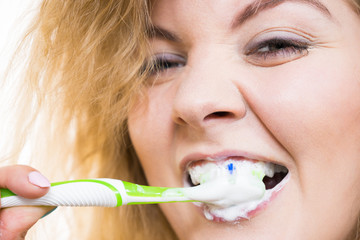 Woman brushing cleaning teeth