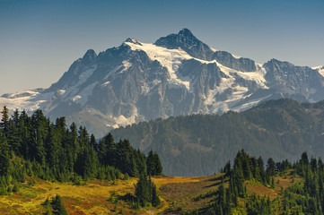 Fototapeta na wymiar View of Mt. Shuksan From The Excelsior Ridge Trail. One of the more spectacular hikes in the Mt. Baker National Forest is the excelsior Ridge hike that combines valley and mountain views.