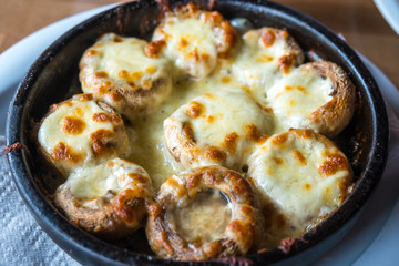 Stuffed mushrooms with cheese on the pot, Georgian cuisene