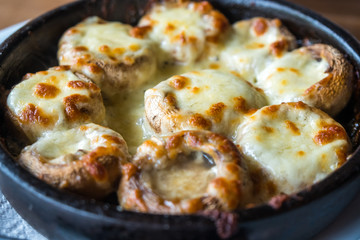 Stuffed mushrooms with cheese on the pot, Georgian cuisene