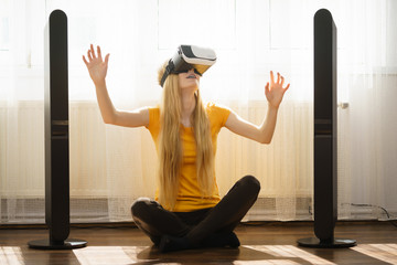 Girl wearing virtual reality goggles at home