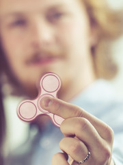 Man playing with fidget spinner