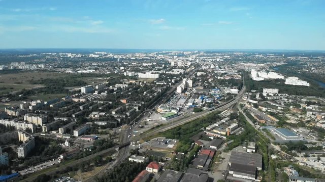 The camera descends on a city with a railway. Aerial view. 4K.