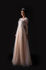 Fototapeta na wymiar Full length of a beautiful bruenette woman in wedding dress