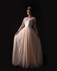 Fototapeta premium Full length of a beautiful bruenette woman in wedding dress