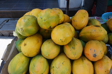 Ripe fruits of yellow papaya stacked at a local market of fruit and vegetable in Sri Lanka