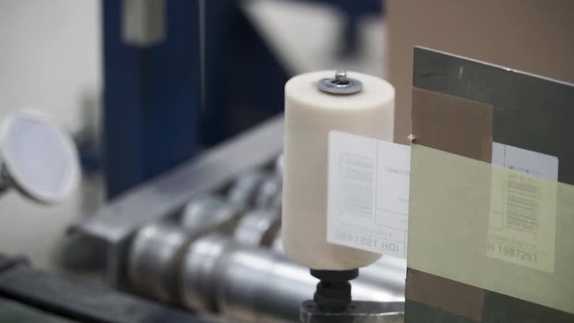 Cardboard manufacture machine propduct line making boxes. Clip. Packed courier on production line against cardboard boxes in warehouse. Cardboard box production line