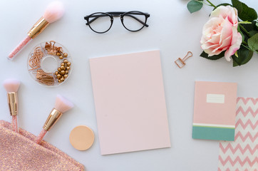 flat lay pink composition with blank note cosmetics, makeup tools, glasses and rose on white background. beauty, fashion, party and shopping concept. Copy space for lettering or text. Blog background.