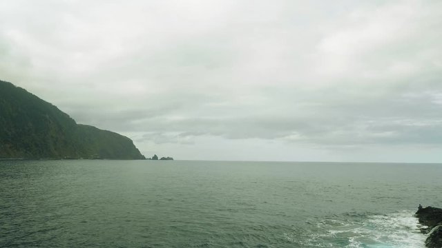 Up view of waves of ocean from cliffy shore of the north of Madeira