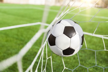 Fototapeta na wymiar Soccer ball in goal, sport concept