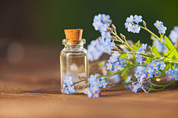 Essence of flowers on table in beautiful glass jar