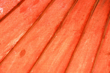Old red Japanese traditional umbrella. Closeup for background. It is made from bamboo and fabric.
