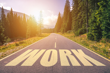 Work word written on road in the mountains