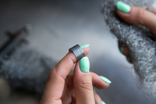The process of making silver jewellery. Female artist hands close up. Crafting a silver ring, see the entire series.