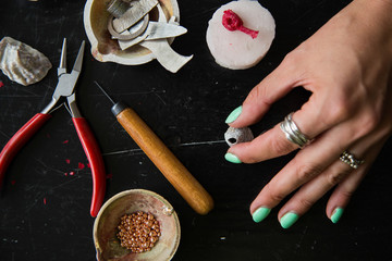 The process of moulding silver jewellery with natural objects like seashells with jeweller's wax
