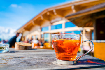 Hot tea cup on the terrace in the mountains ski resort.