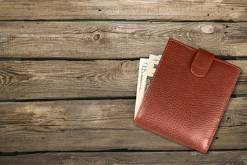 Leather wallet on wooden table