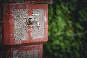 Closeup of an old sink in a bricked wall