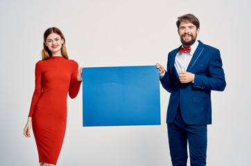 young couple holding a blue background place free