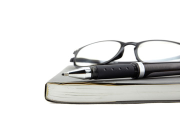 A black pen and empty open book on white background