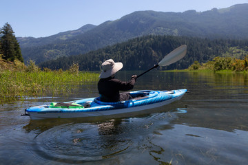 Kayaking in Harrison River during a beautiful and vibrant summer day. Located East of Vancouver,...
