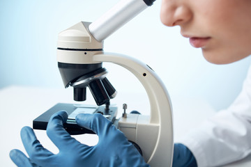 scientist looking through microscope