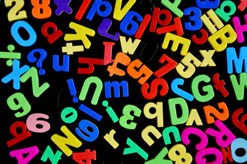Mixed Letters and Numbers Scattered on a Magnet Board
