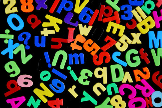 Mixed Letters and Numbers Scattered on a Magnet Board - Powered by Adobe