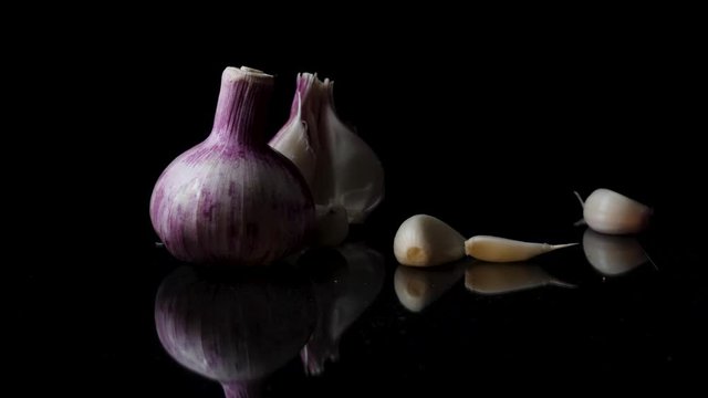 Onions, garlic and spices isolated on black background. Frame. Composition of onions and falling garlic isolated on white background