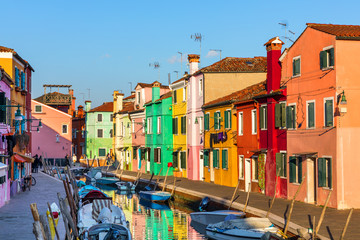 Beautiful view of the canals of Burano with boats and beautiful, colorful buildings. Burano village...