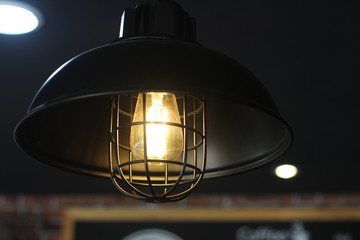 Fototapeta na wymiar Light bulb incandescent hanging decorative interior room.