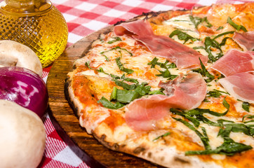 handmade prosciutto pizza prepared on a clay furnace pizza