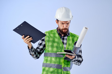builder in a helmet with drawings