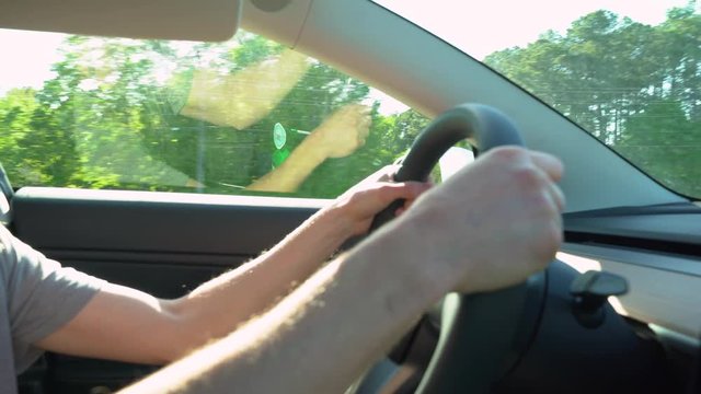 Person driving an electric vehicle on a bright afternoon