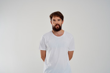 man with a beard in a white T-shirt logo