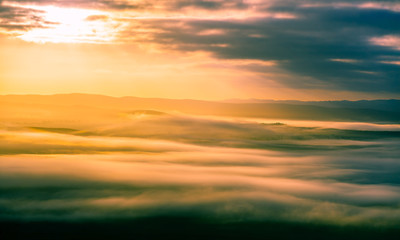 Sunrise glowing over low fluffy clouds in the mountains of South Australia