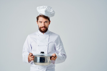 cook holds the kitchen pan