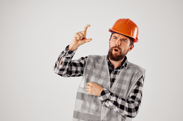 a builder in a helmet keeps his fingers free