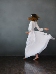 Fototapeta na wymiar woman in a white dress dance