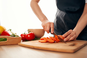 woman cutting vegetables in kitchen