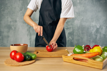 cook prepares to eat cutting vegetables kitchen