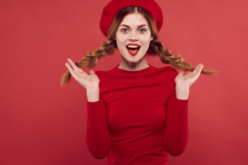 woman in braids in beret on a red background