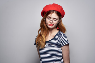 woman in a red beret with closed eyes with glasses