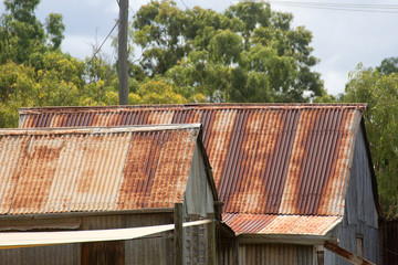 Rusty roof on a corrugated metal house near Irvinebank on the Atherton Tableland in Queensland,...