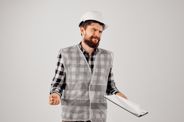 builder in a helmet with drawings