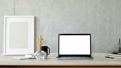 Mockup blank screen laptop and poster on white desk. workspace and copy space