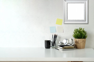 Stylish workspace with mockup poster and gadget..Workplace desk and copy space.
