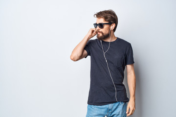 man in glasses listening to music on headphones