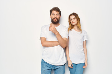 young couple in white t-shirts logo man with a beard woman with flowing hair